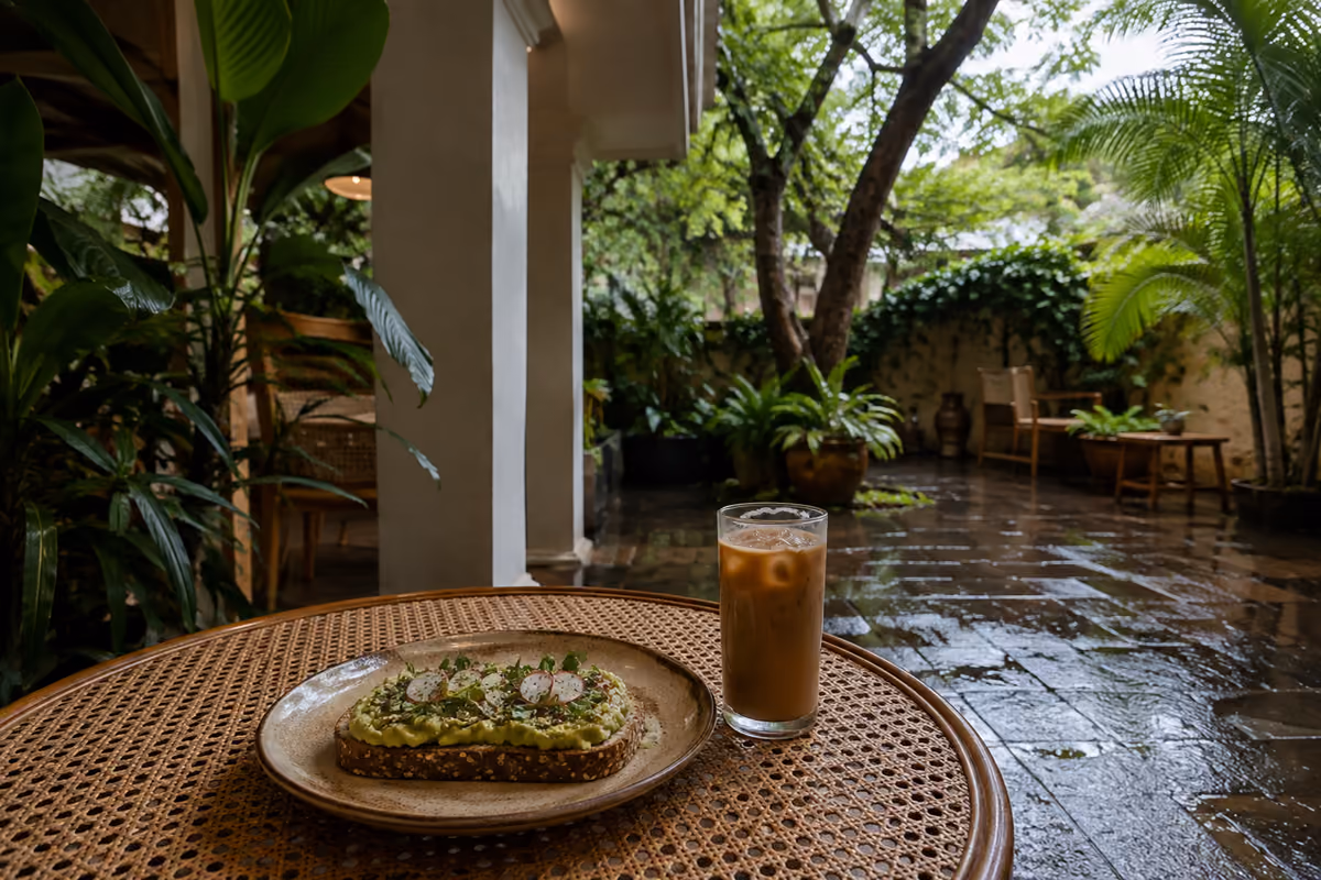 Avocado toast and iced coffee in a quiet JP Nagar cafe courtyard